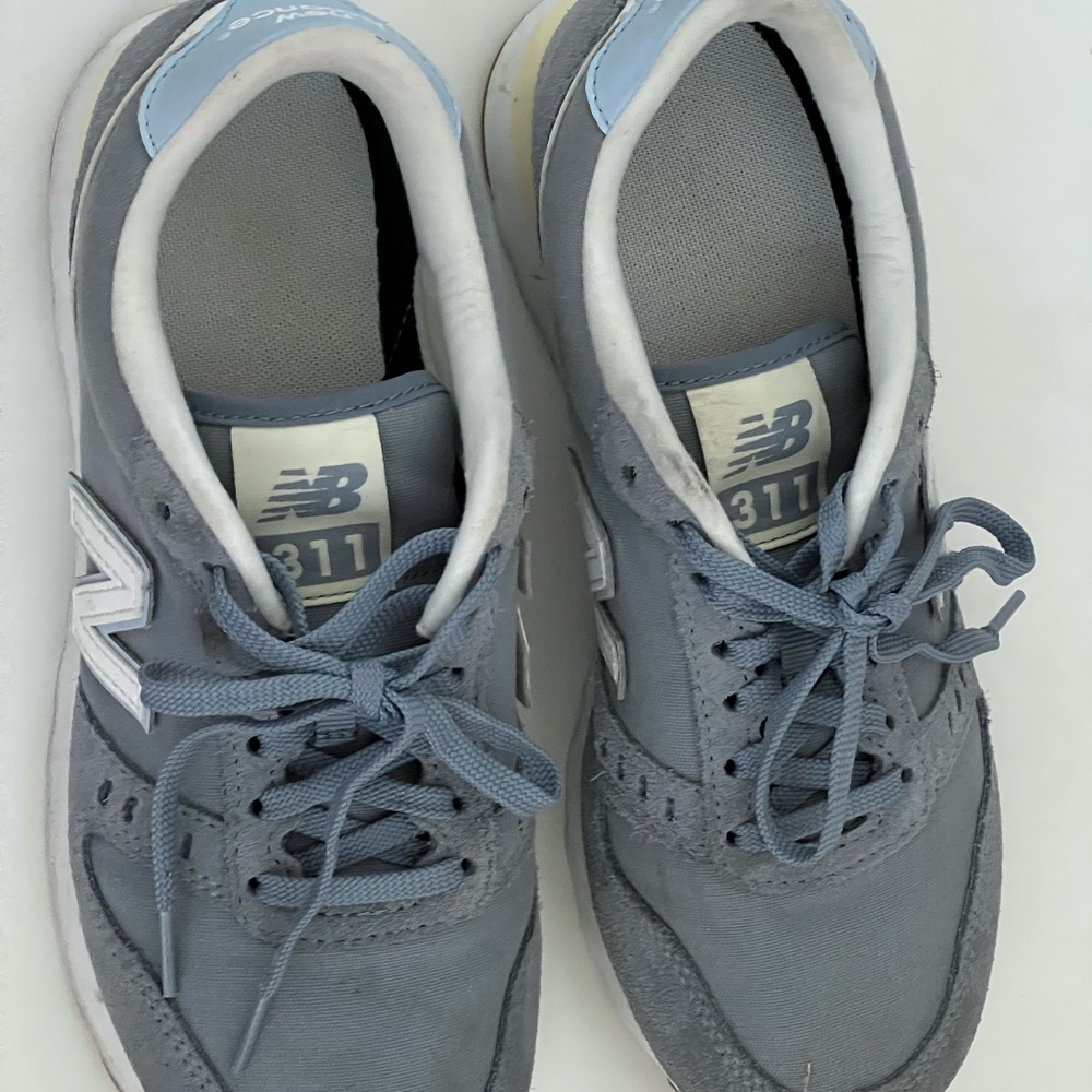 Blue and yellow 311 New Balance sneakers